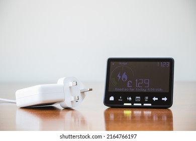 Smart meter placed next to an electric plug - Shutterstock ID 2164766197