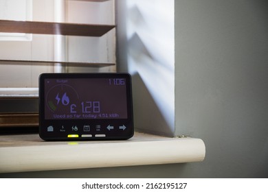 Smart meter placed on an interior window sill next to blinds - Shutterstock ID 2162195127