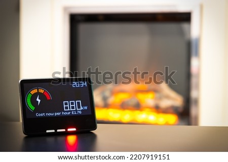 Smart meter showing high energy costs and an electric fire in the background