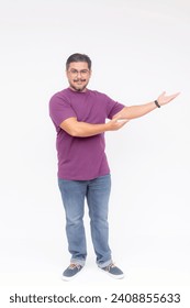 A smart middle aged man eagerly presenting something to the right. Wearing a purple waffle shirt and jeans. Full body photo, isolated on a white background.
