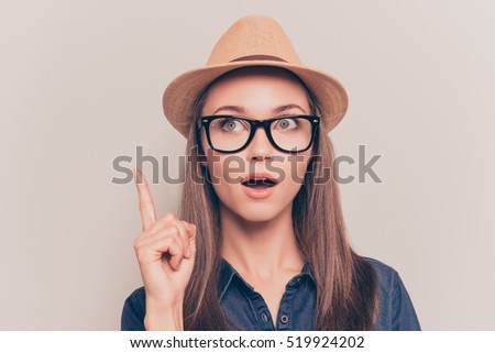 Smart minded woman with raised finger having an idea