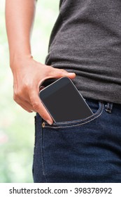 Smart mobile phone in jeans pocket with blank screen.
