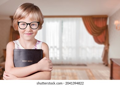 Smart And Nerd Kid Girl Holding Bible For Study In Church.