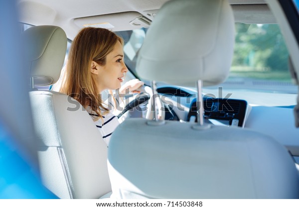 Smart nice woman sitting in\
the car