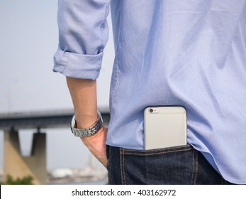 Smart phone in the back pocket of blue jeans