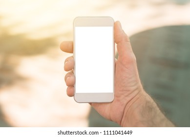 Smart Phone With Blank Screen In Male Hand. Mock Up Copy Space For Mobile App Screenshot.