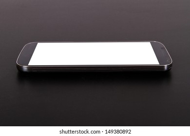 Smart Phone With Blank, White Screen, Side View On Wooden Table.