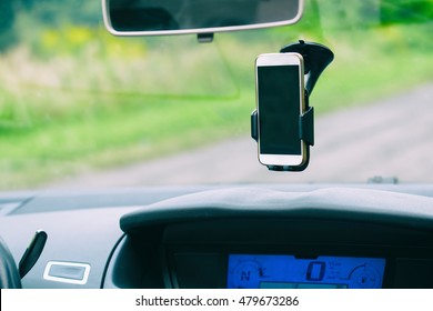 Smart Phone In The Car Holder On The Windshield