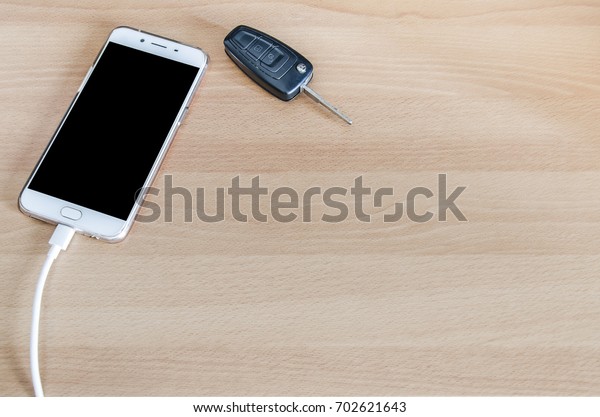 Smart phone is\
charging on corner the\
desk