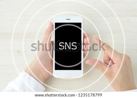 Smart phone and concentric circles with sns logo