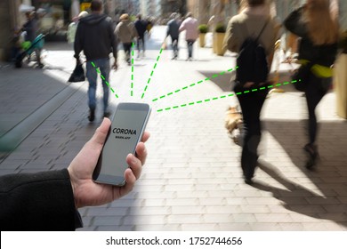 Smart phone with Corona Warn App, a contact tracking or tracing application against Covid 19 pandemic is connecting other phones from moving people in the city to analyze the risk of infection - Shutterstock ID 1752744656