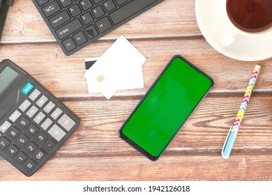 Smart Phone And Credit Card On Wooden Table, Top View 