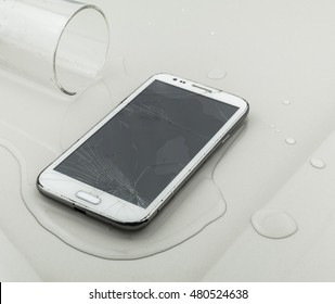 Smart Phone Fail Broken On Tile Floor With Water Spilled
