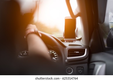 Smart phone with smart phone holder in car.