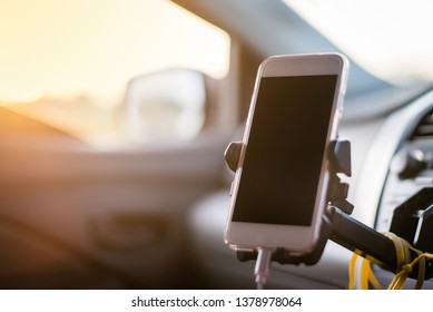 Smart Phone With Holder In Modern Car Use For Navigate ,GPS, Listening, Podcast, Speech, Music, YouTube