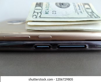 Smart phone and money in dollars bill from online business or e-commerce as a way to make more income with blank grey space which can be used as copy space.