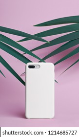 Smart Phone On A Pink Background Of Palm Leaves In A White Plastic Case Back View. Mock Up Of Phone Case For IPhone 8 Plus