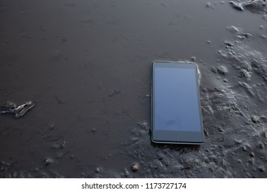 Smart Phone In The Puddle