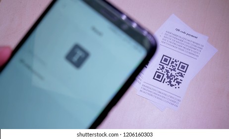 Smart Phone Scanning QR Code In Paper Label Or Payment Check. Concept Of Payment , Online Shopping And Cashless Technology