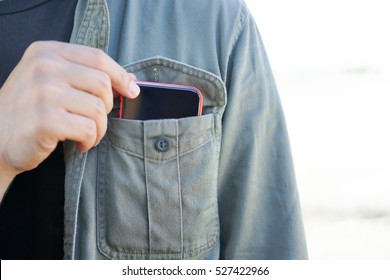 Smart Phone In Shirt Pocket Of A Asian Adventure Man, Technology Smartphone Background Concept