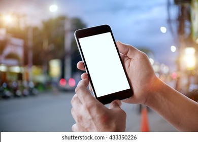 Smart phone showing blank screen in man hand at walk street,night light bokeh Background - Powered by Shutterstock