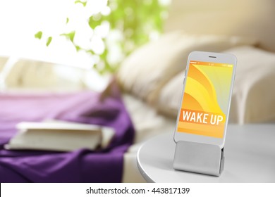 Smart Phone With Stand On A Bedside Table In A Room