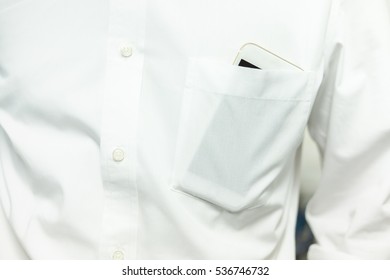 Smart phone in white shirt pocket of a business man - Shutterstock ID 536746732