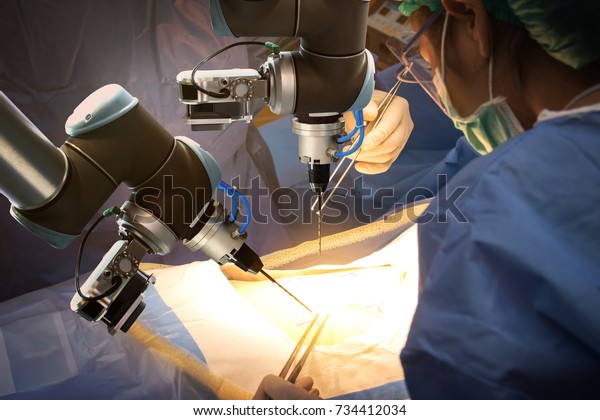 Smart precision healthcare\
technology , artificial intelligence concept. Automation robot hand\
machine in operating room and surgery doctors in futuristic\
hospital.