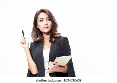 Smart Professional Asia Business Woman In Black Suit And White Dress Holding Pen And Tablet Thinking New Project On White Background,business Woman Concept Idea.