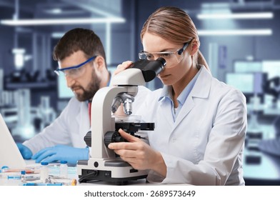 Smart Researcher using modern microscope in lab