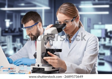 Smart Researcher using modern microscope in lab