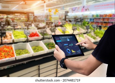 Smart Retail Management System.Worker Hands Holding Tablet On Blurred Supermartket As Background