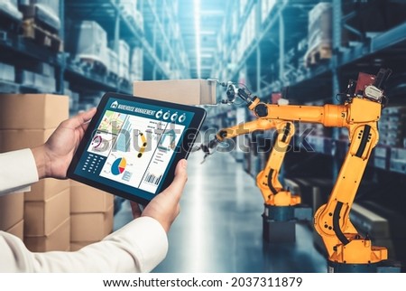Smart robot arm systems for innovative warehouse and factory digital technology . Automation manufacturing robot controlled by industry engineering using IOT software connected to internet network .