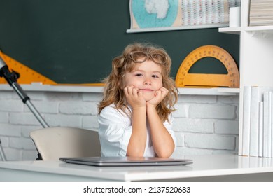 A Smart School Boy Sitting At The Table, Preparing For The Exam.