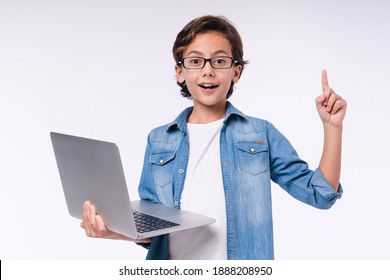 Smart small male kid having idea with laptop isolated over white background