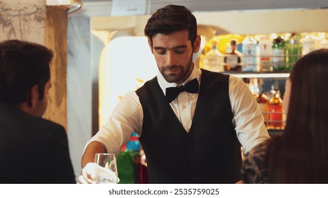 Smart smiling bartender preparing drinks putting ice into glass at luxurious bar while engaging lively conversation with VIP customer at vibrant warm lighting atmosphere pub and restaurant. Vinosity. - Powered by Shutterstock