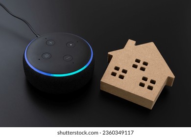 Smart speaker and home objects on black background.