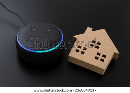 Smart speaker and home objects on black background.