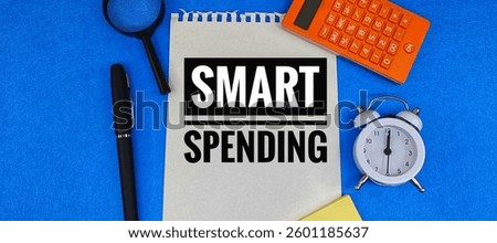 Smart Spending Strategy – Notebook with ‘Smart Spending’ Text on Office Desk with Calculator, Pen, and Financial Documents – Budgeting, Expense Management, and Financial Planning. 