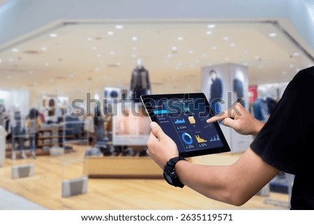 Smart store management systems concept.Manager using digital tablet on blurred store as background