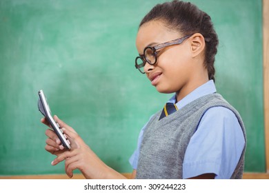 Smart student holding a calculator at the elementary school - Shutterstock ID 309244223