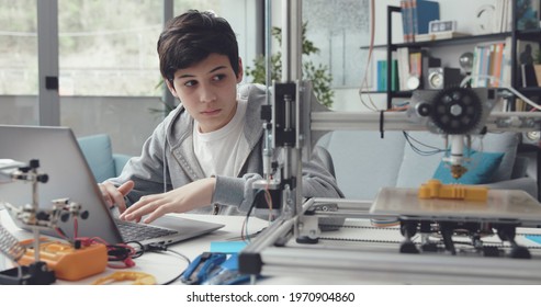 Smart Student Using A 3D Printer At Home, He Is Creating A Prototype On The Laptop