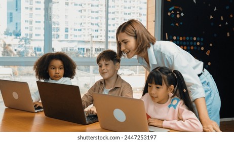 Smart teacher teaching and looking student using laptop at classroom. Professional instructor explained about programing engineering code or prompt while studying and learning program. Erudition. - Powered by Shutterstock