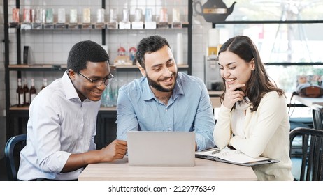 Smart team worker sitting in the coffee shop watching laptop taking break time together  - Shutterstock ID 2129776349