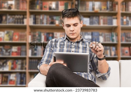 Smart tech. Positive guy use touch pad device to learn or work online
