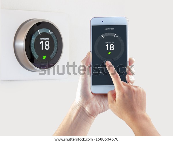 Smart Thermostat with a person saving\
energy with a smart device on a white\
background