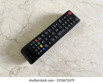 Smart TV Remote Control On Beige Marble Table. Close Up, Top View