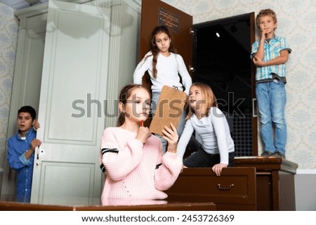 Smart tween girl trying to solve conundrum to get out of escape room with her friends