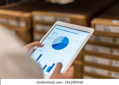 Smart warehouse management system with worker - Shutterstock ID 1411583318