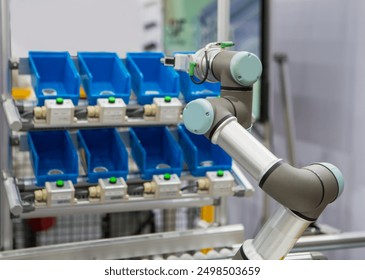 Smart warehouse. Robots pick up parts from plastic bin rack.  - Powered by Shutterstock